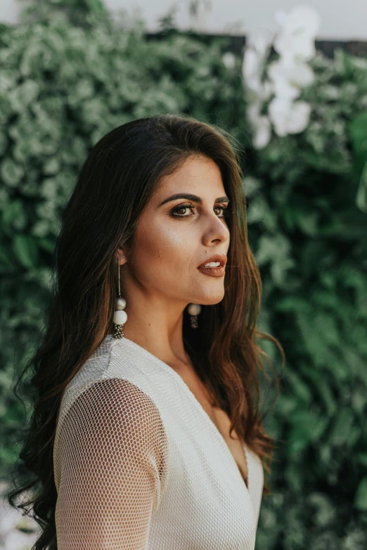 woman in white mesh dress with earrings