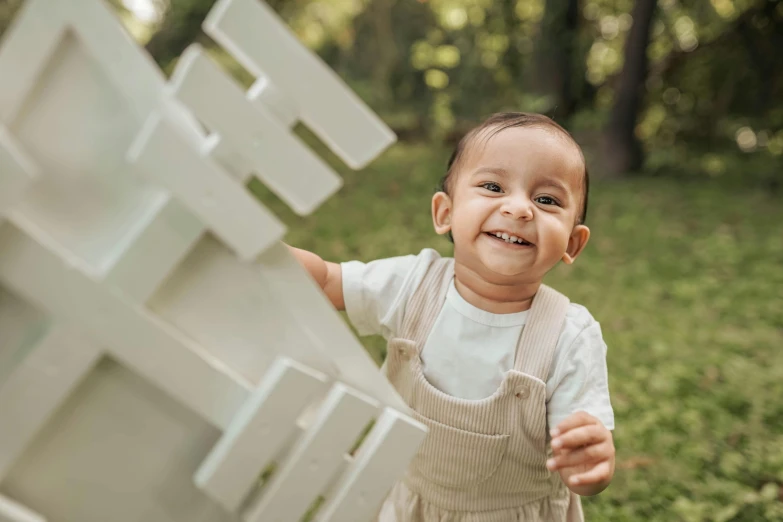 a little boy is smiling as he looks up at the camera