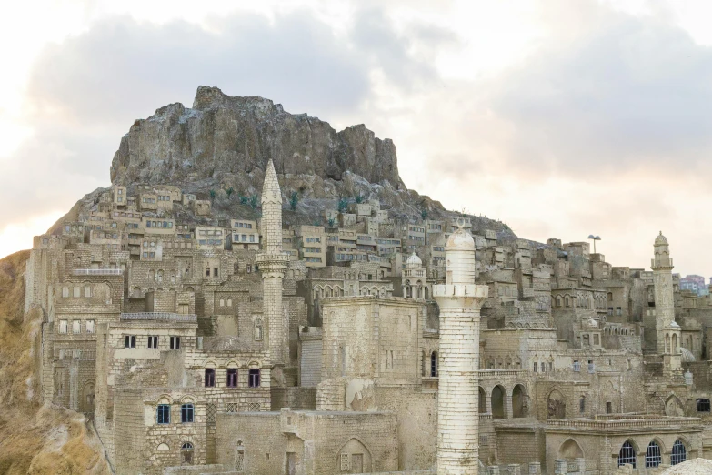 stone buildings that are built near a big hill