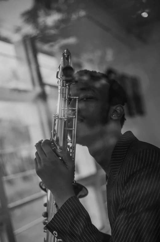 a man holding his saxophone as he poses for a picture