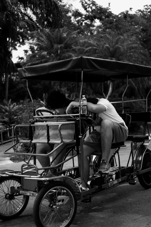 an old man riding a car with a passenger