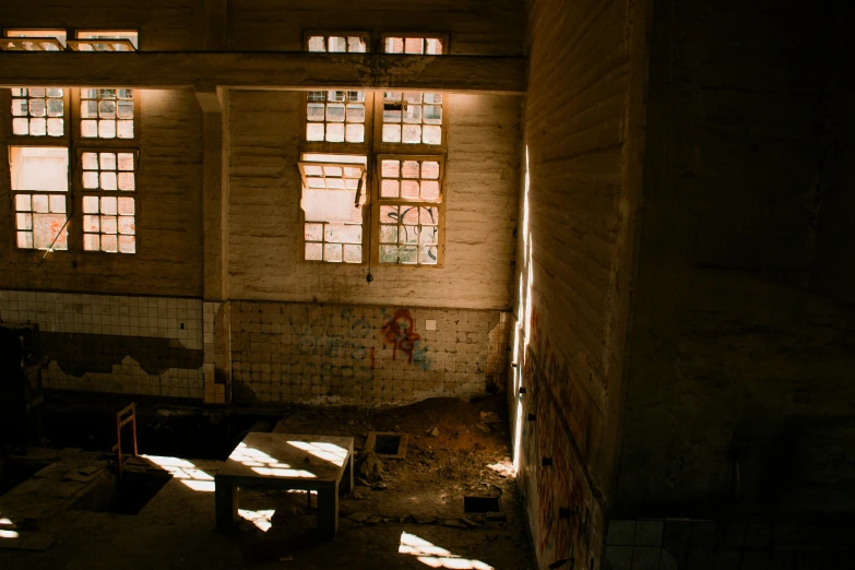 a dimly lit room with two large windows