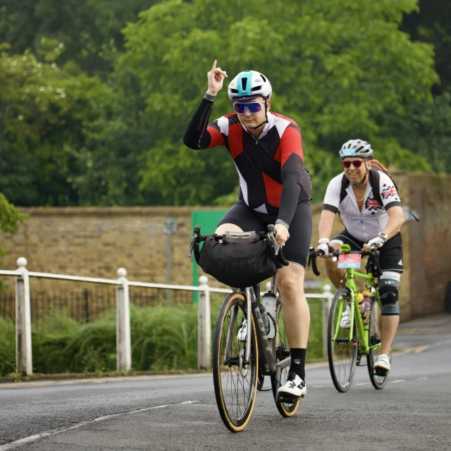 two people are riding bicycles in the street