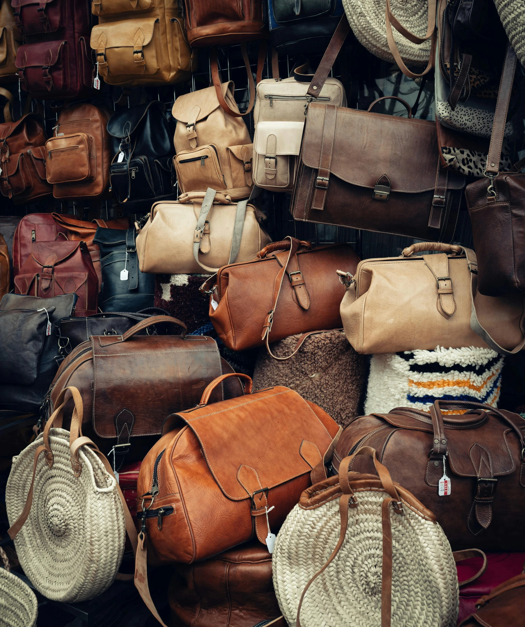 a large collection of purses and baskets on display