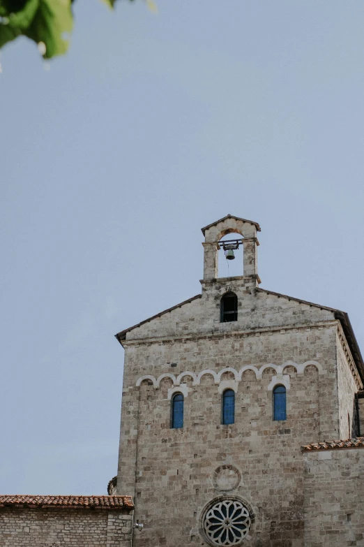 an old church building with a clock and bell tower