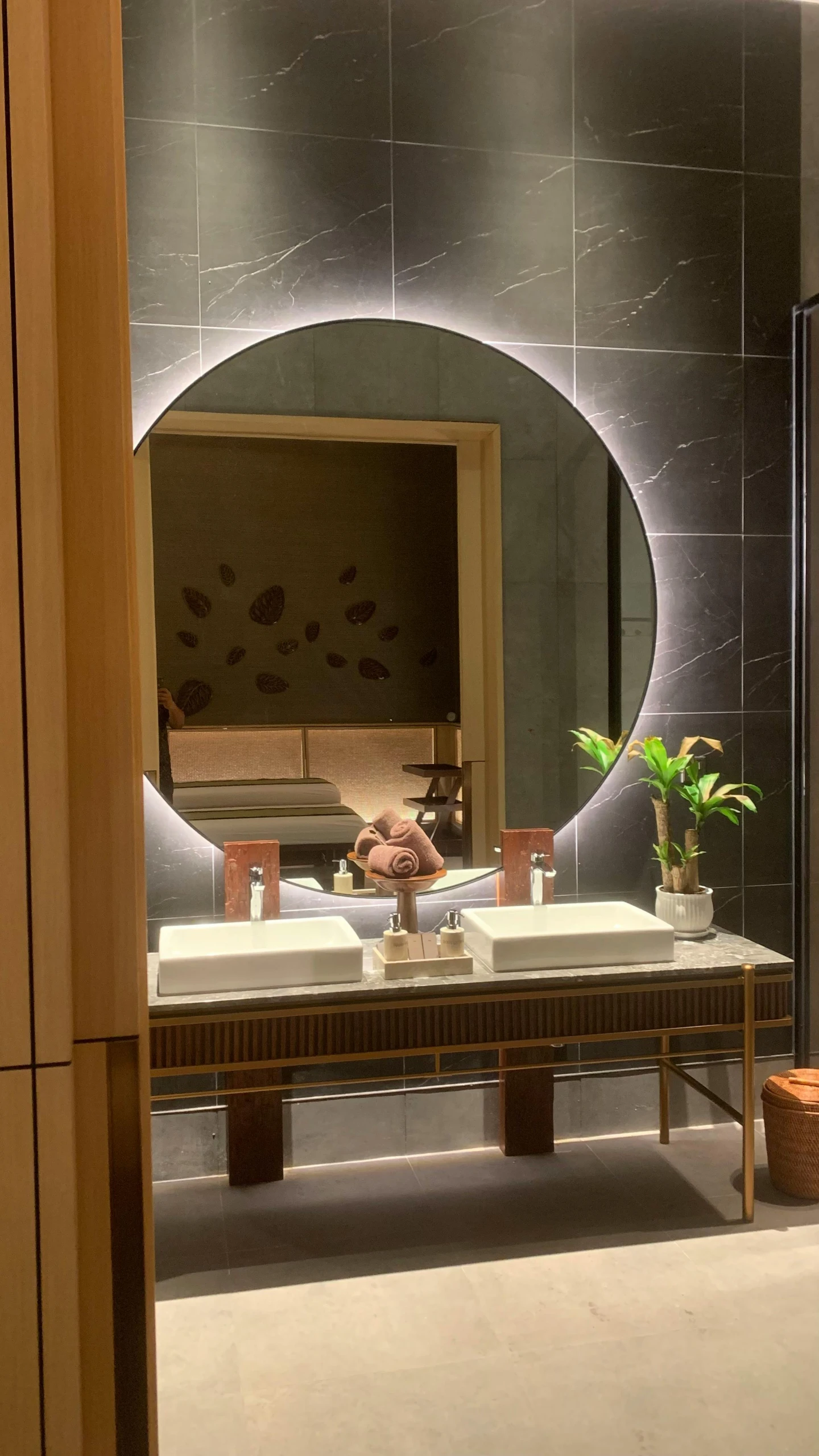 a modern looking bathroom with marble counters and a mirror