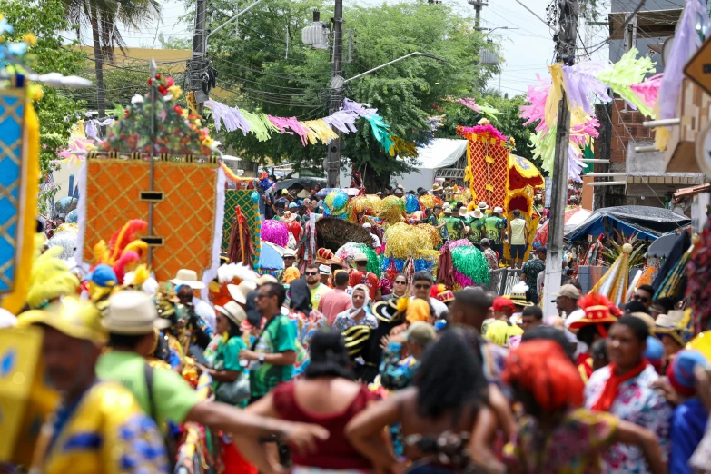 an open air festival with many people dressed in costume and colors