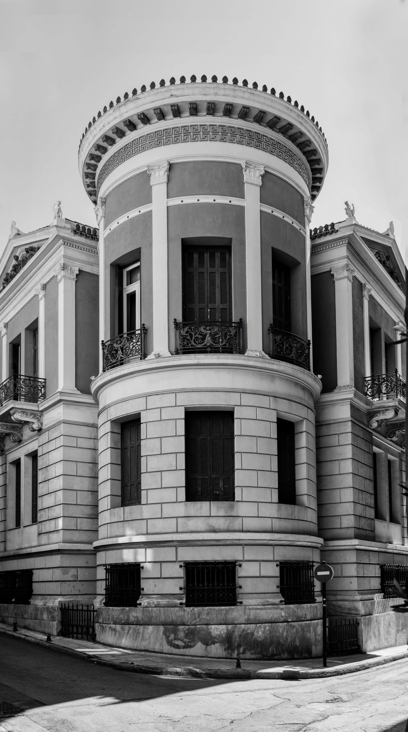 a building with an ornate balcony sitting on the corner