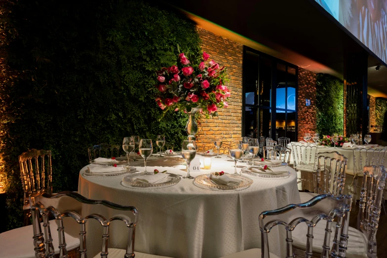 a table with white cloths set for a meal