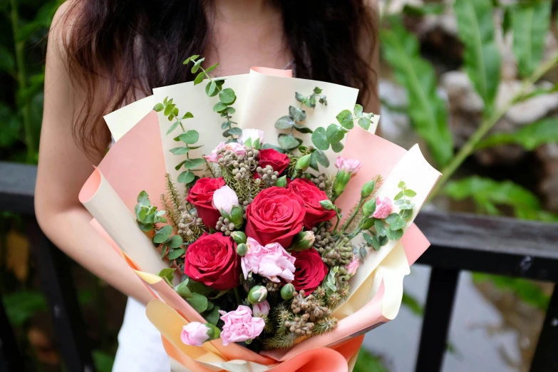 woman in a white dress holding a bouquet of flowers