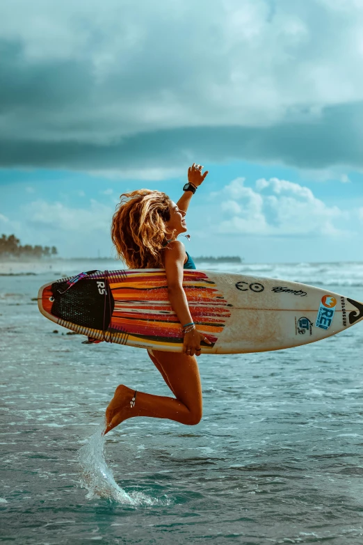 a woman with a surfboard in the air