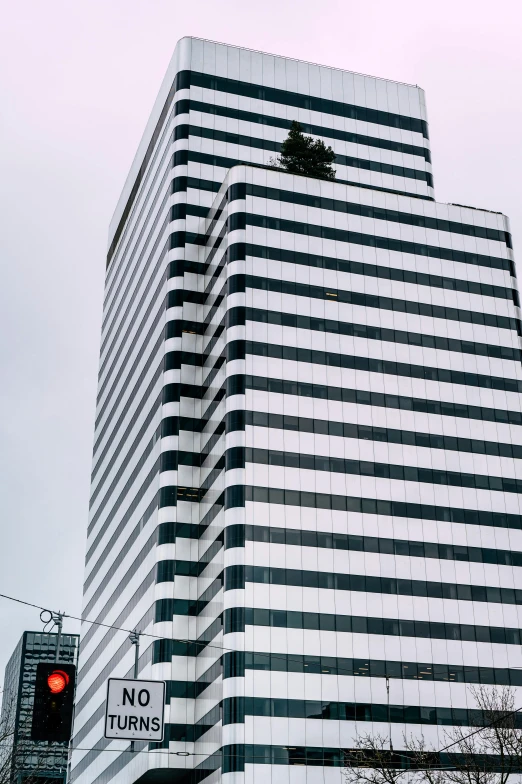 a very big building with a red traffic light in front