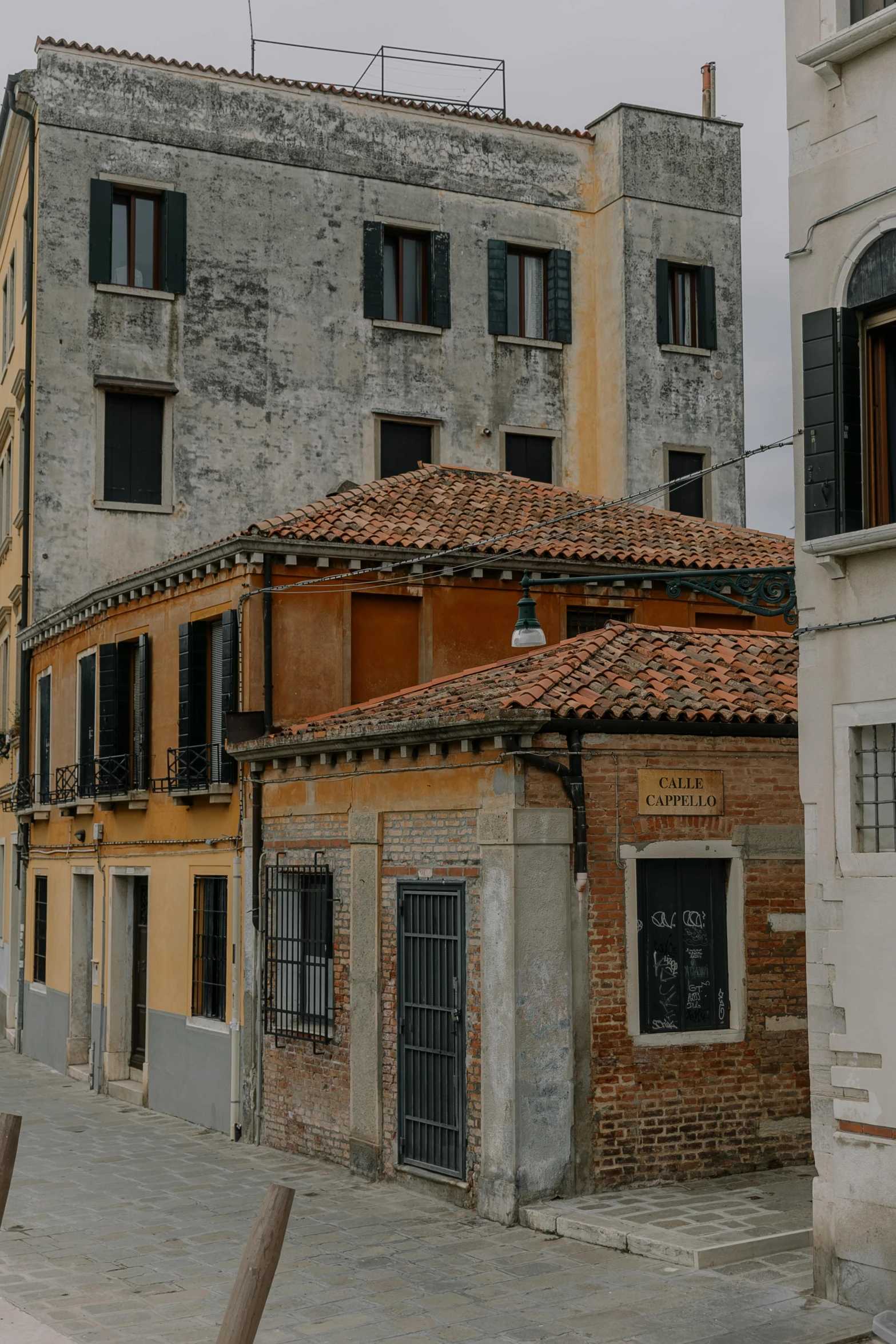 a building with a red tiled roof and windows on both sides