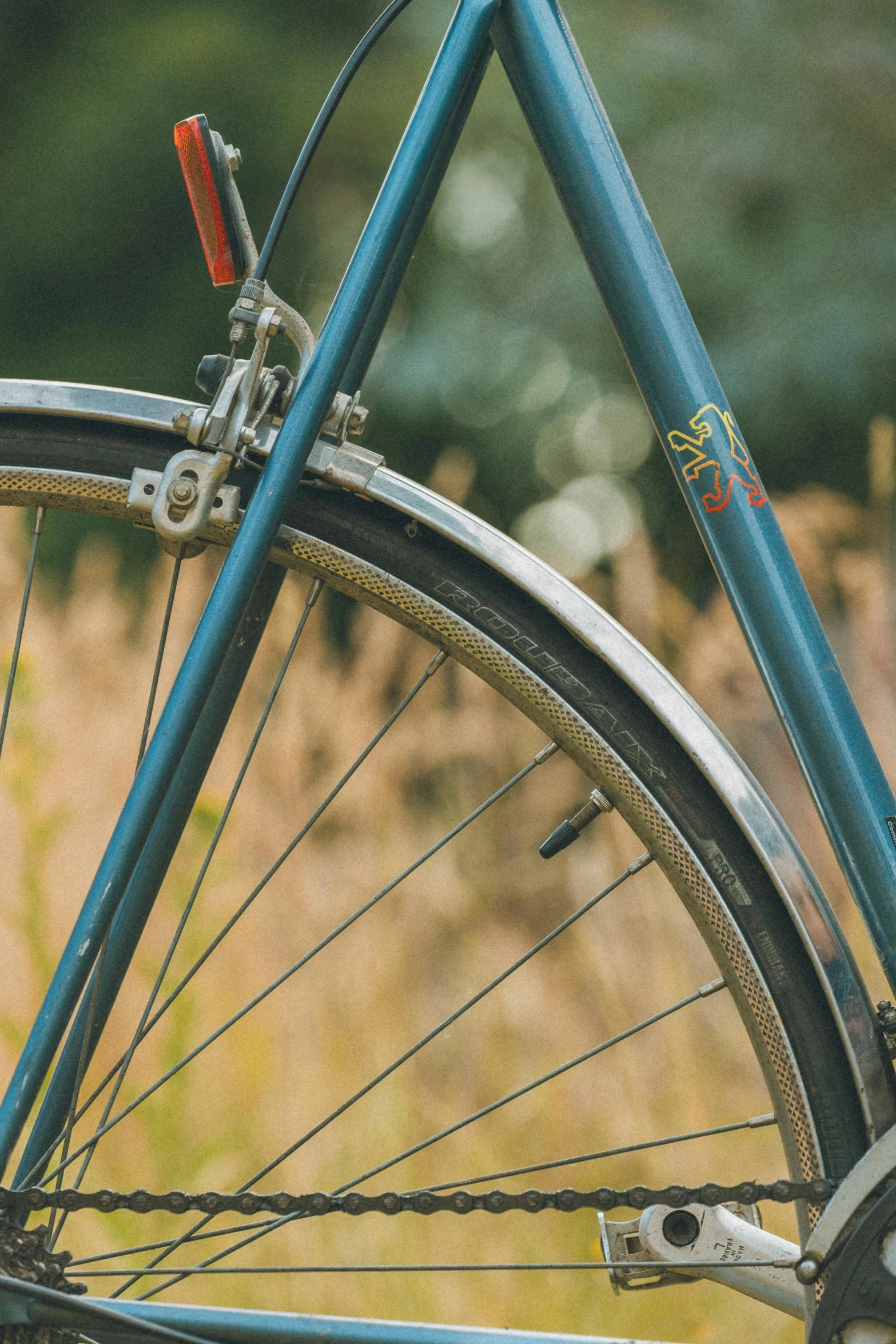 the wheels and front end of a blue bicycle