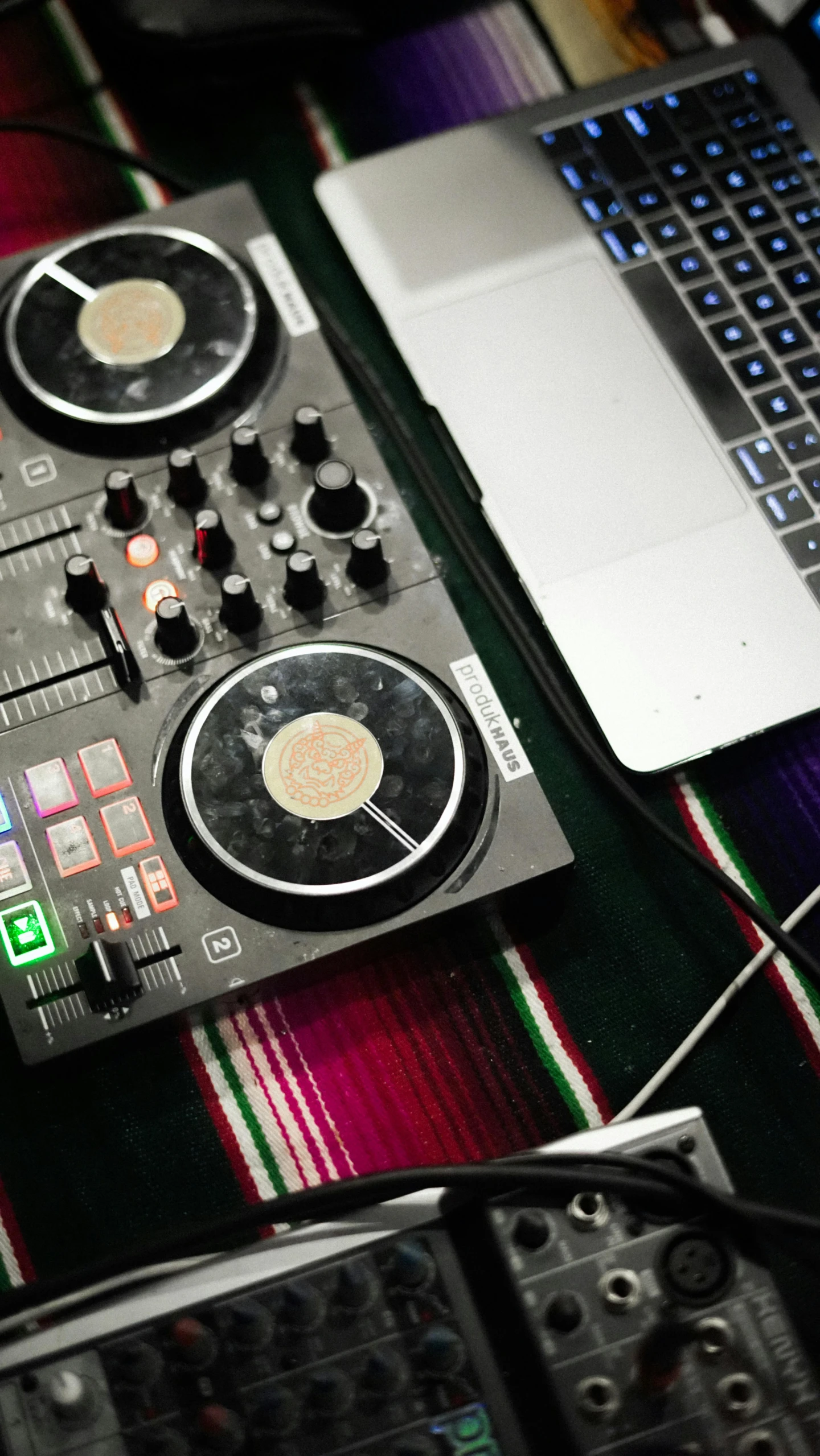dj equipment on a colorful cloth with a laptop