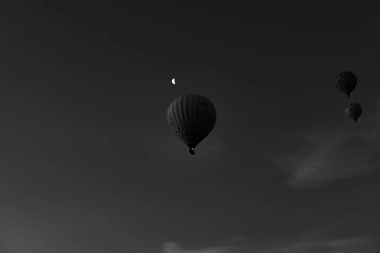 three  air balloons flying high up in the sky