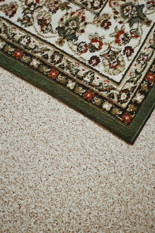 the texture of a rug is white with brown and red flowers