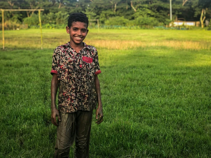 a child stands in the middle of a field
