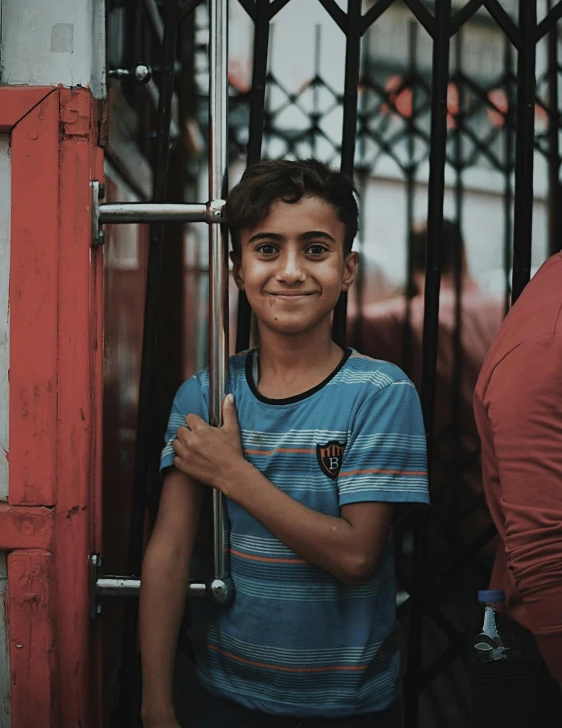 a smiling  holding onto the gate