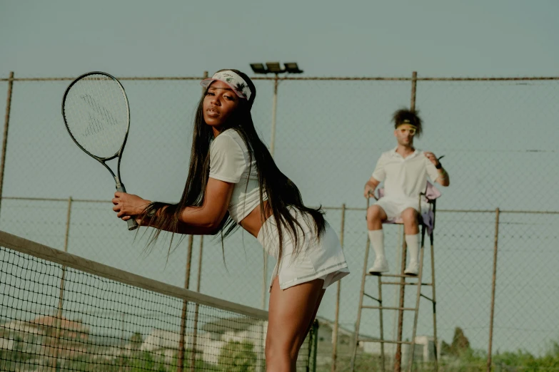 a man standing on top of a tennis court holding a racquet