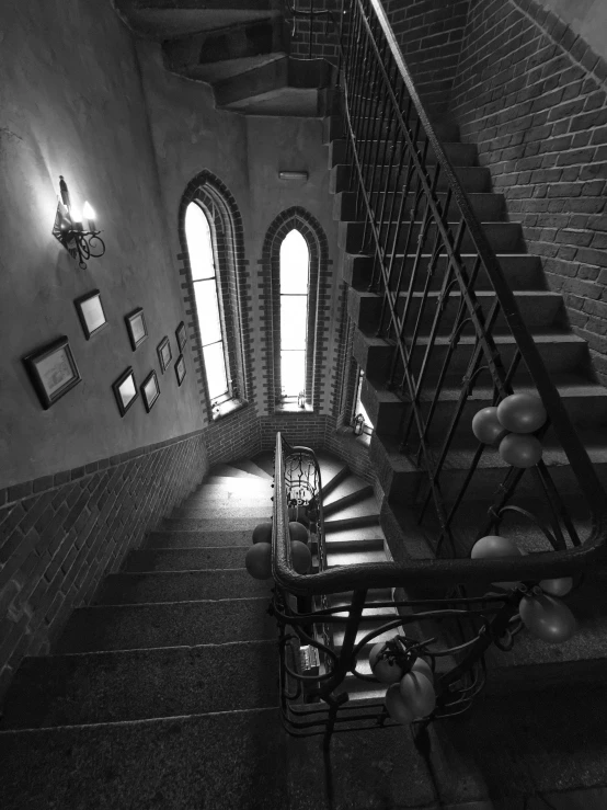 a staircase with a large windows and arched doorways