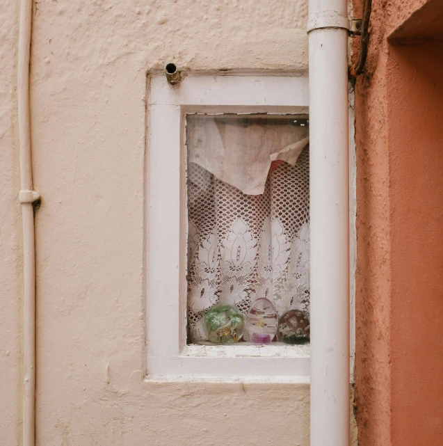 a wall and a window with lace on it