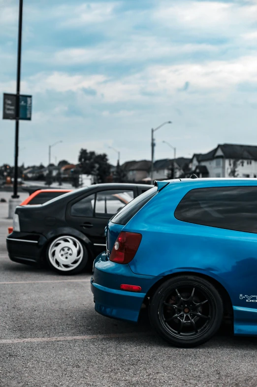 two cars are parked near each other in the lot