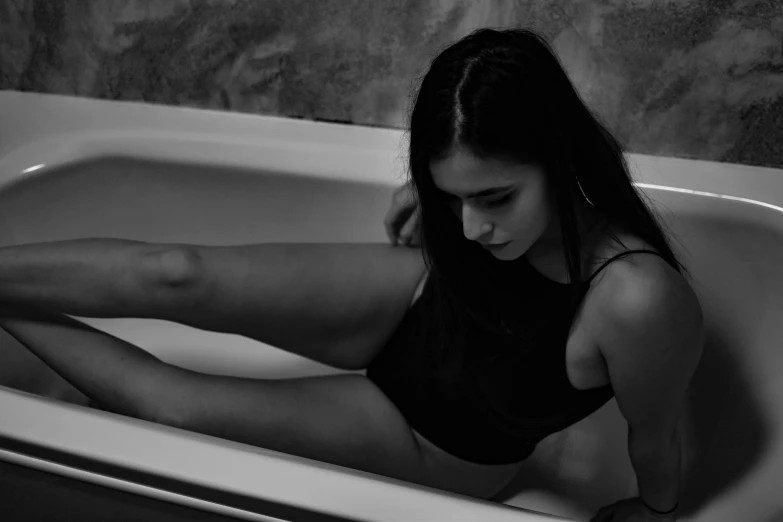 a young woman sitting in a tub posing