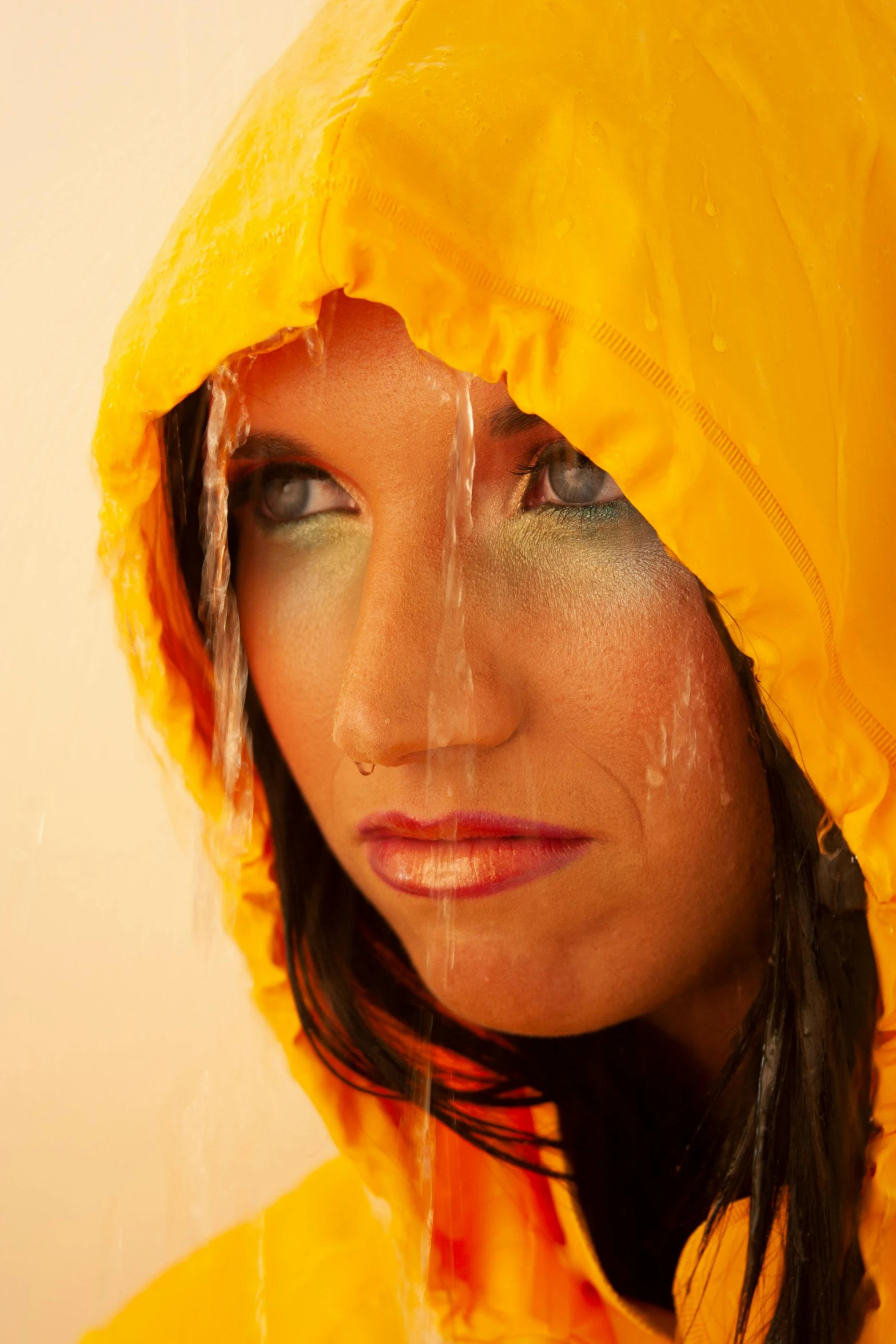 a woman in yellow is wearing rain coats