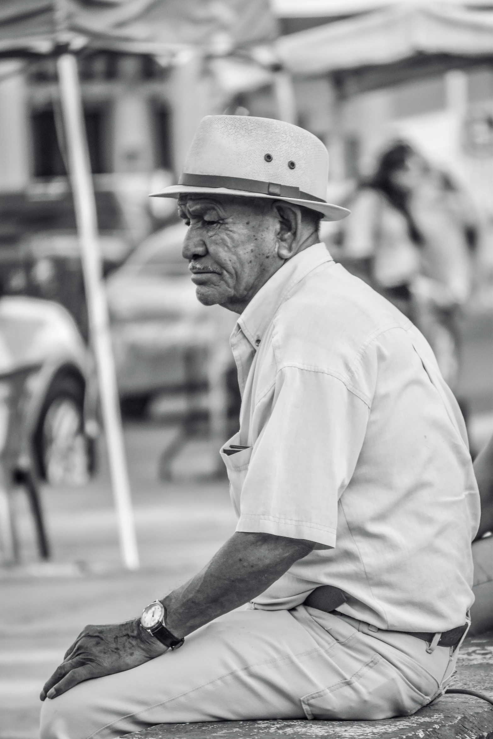 the man in the hat is waiting on his car