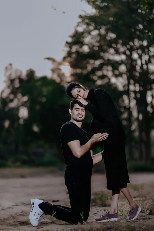 the couple are posing for a po in the woods