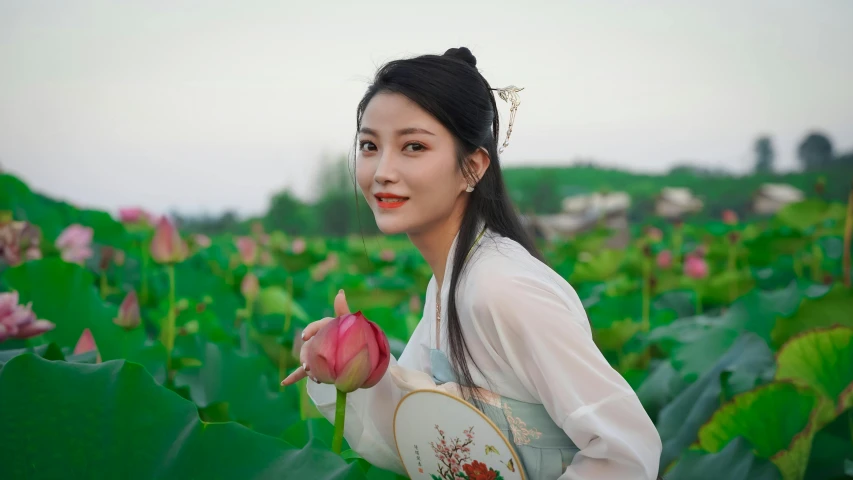 a young woman in the middle of flowers posing