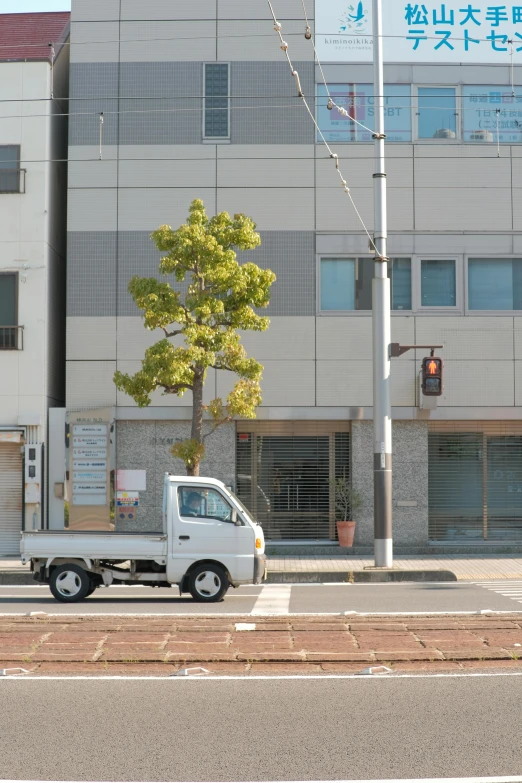 a large truck drives past a small street intersection