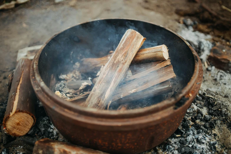 wood sticks are piled on top of an open fire pit