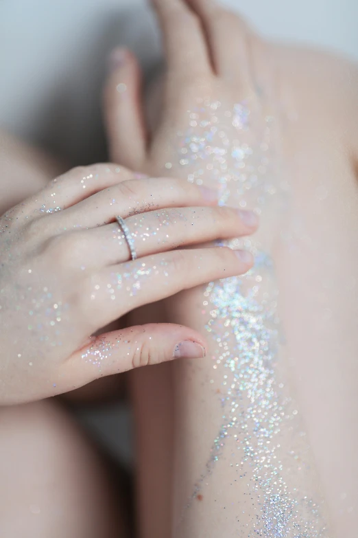 a woman with her arm covered in glitter