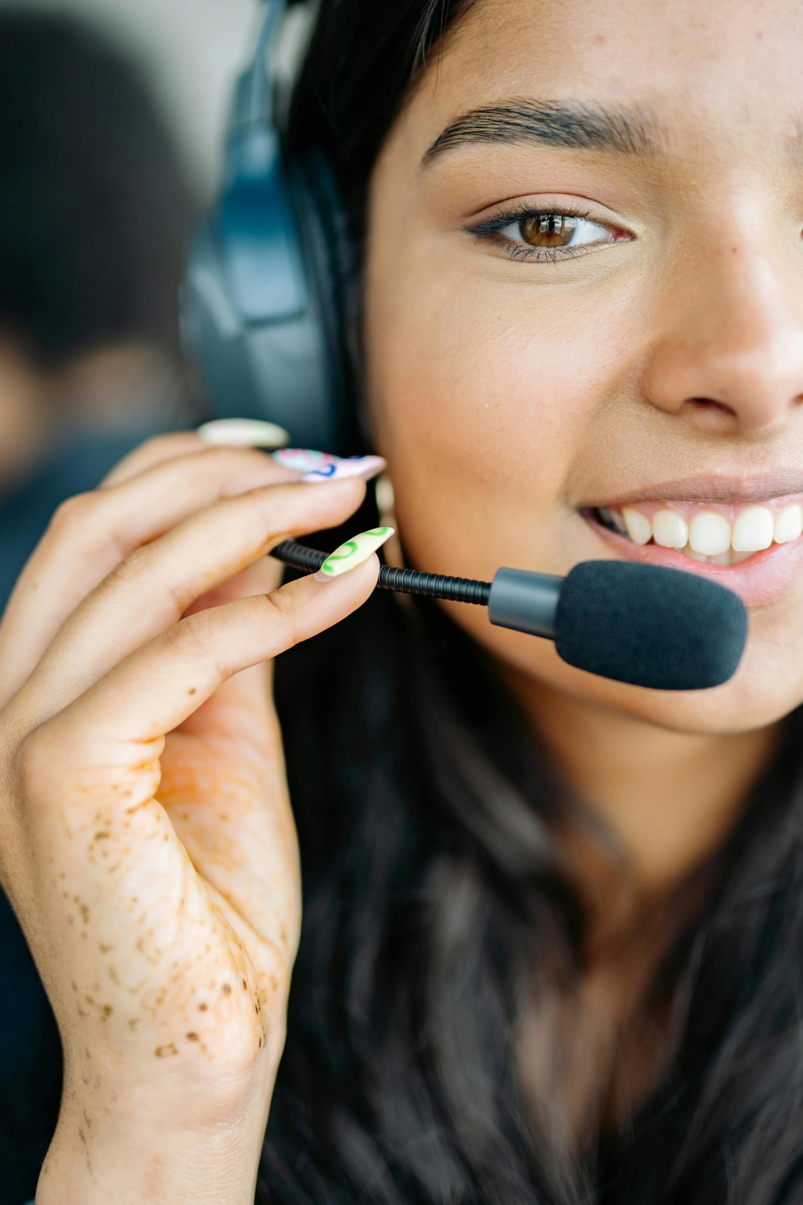 a woman wearing headphones talking on a microphone