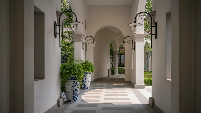 an archway with a checkered walkway going to a door