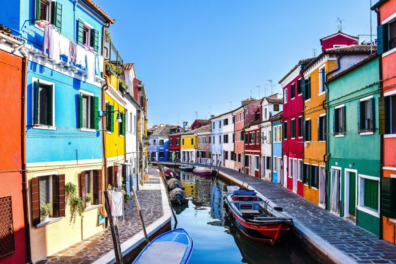 boats are parked at a harbor in front of buildings