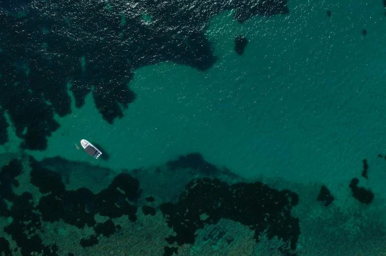 a boat is out in the water near rocks