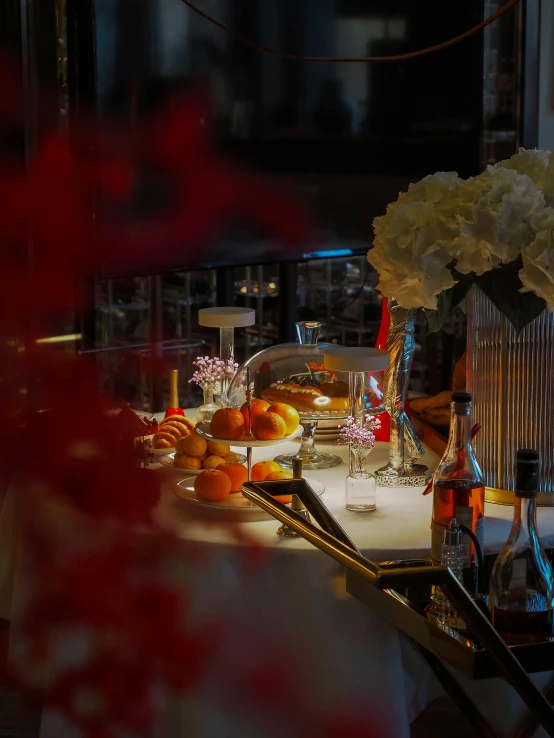 a table with plates and glasses, candles, flowers and utensils on it