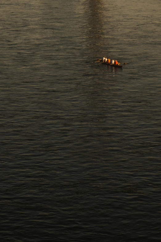 a couple is rowing in a boat on the ocean