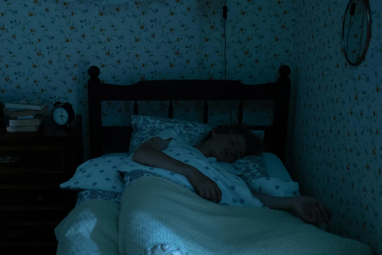 a young child asleep in the bed at night