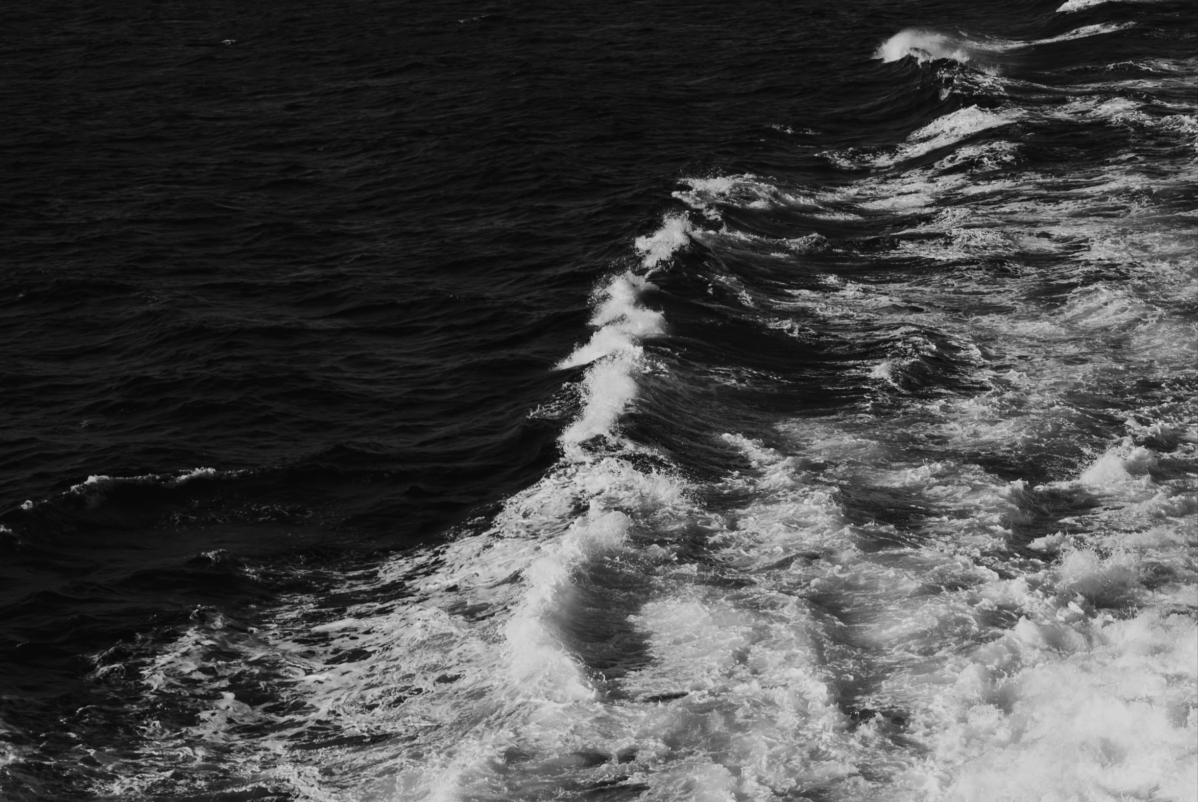 large waves roll over the surface of the ocean