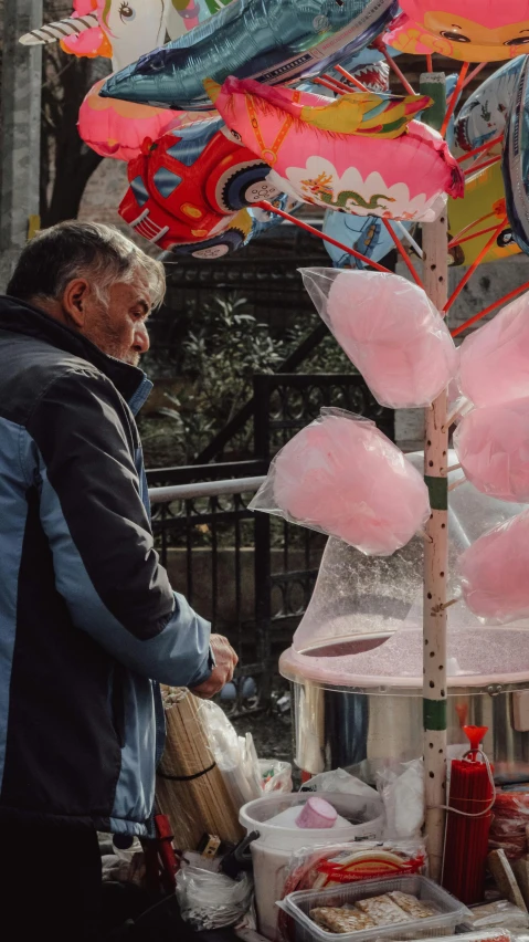 man selling oriental decorations in front of street vendor