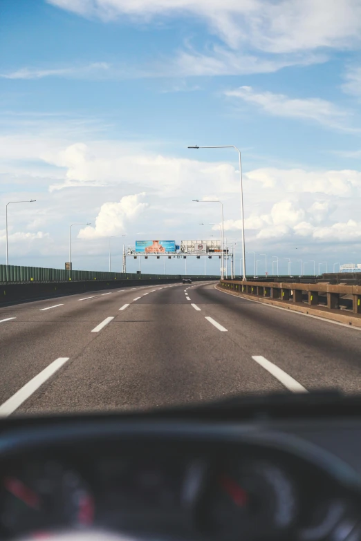 a highway with an overpass in front of some cars