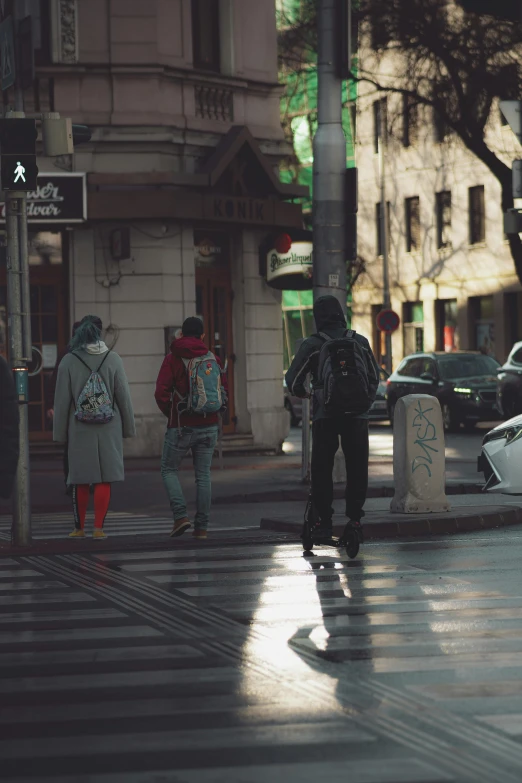 a couple of people are walking in the rain