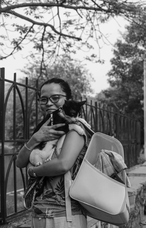 black and white pograph of a woman holding her cat