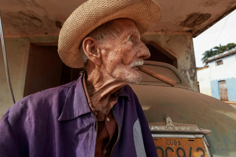 a man wearing a cowboy hat smoking a cigarette