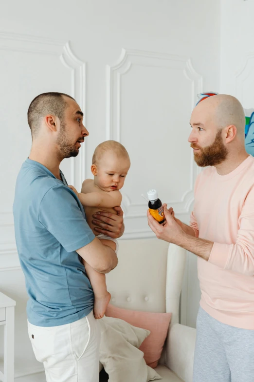 a man holding a baby in his arms