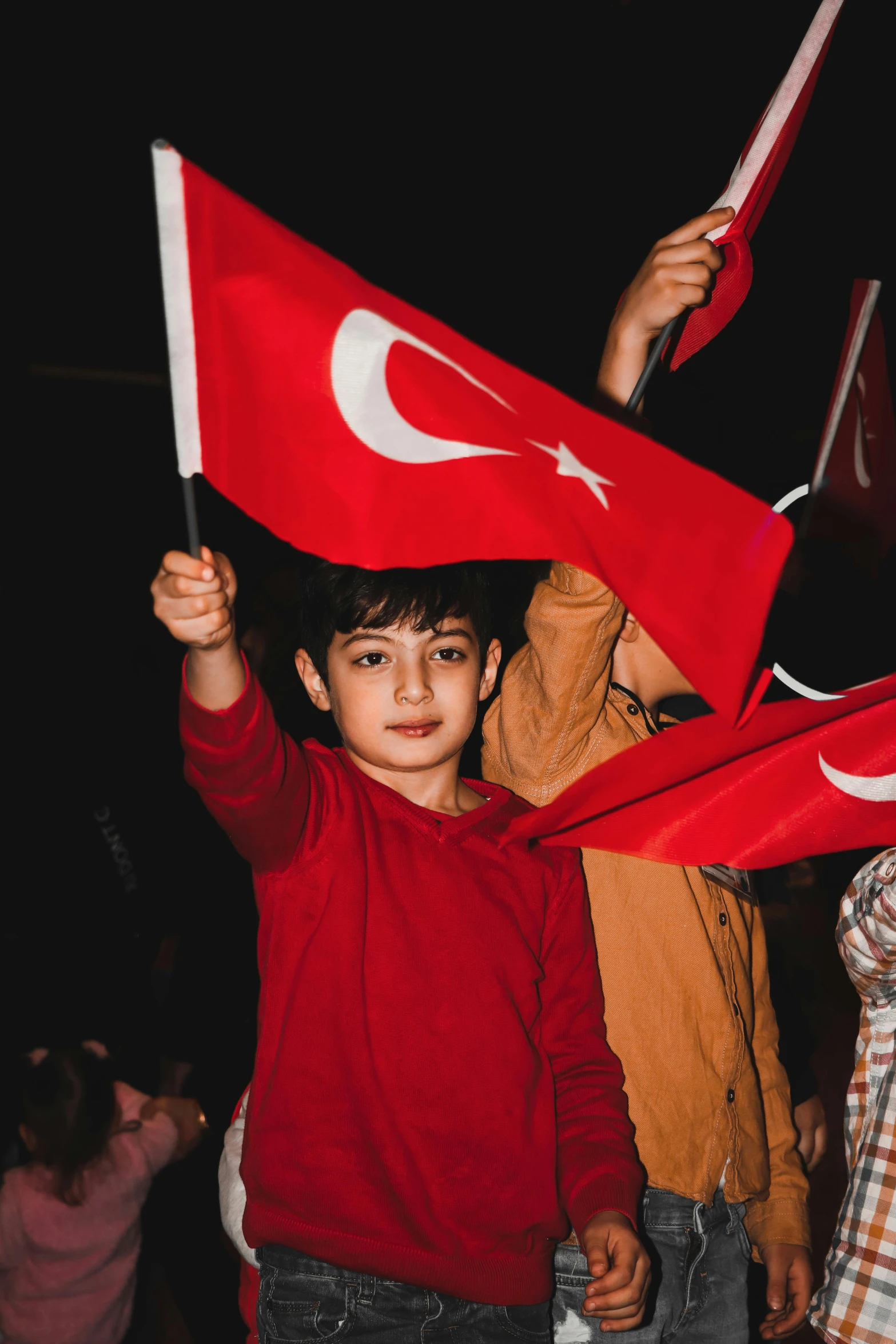 the two boys are holding flags in their hands